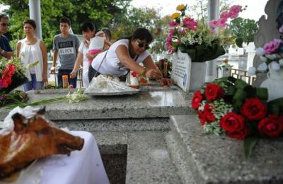 Chinos honran a sus muertos en Cuba comiendo cerdo y quemando billetes falsos